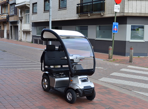 Blankenberge, West-Flanders, Belgium-September 30, 2023: a 2 seat places electric go cart for a simple and easy journey in a city by the sea with an electric golf cart
