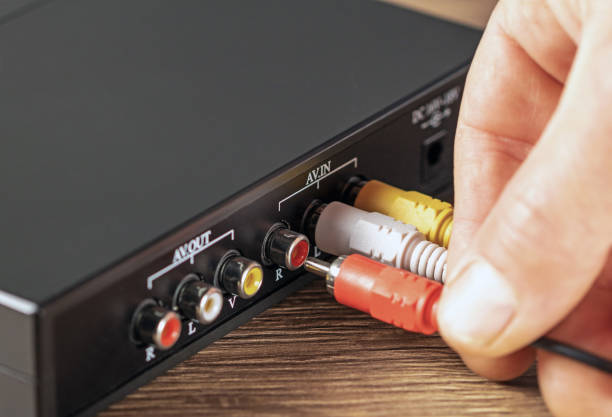 istock Close-up hand connecting a plug to a color music amplifier 1718825161
