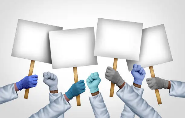 Health Care Workers Strike as medical staff picketing and a Hospital worker group at a picket line striking for better benefits and working conditions with blank picket signs.
