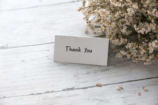 Thank you note with a bouquet of flower.