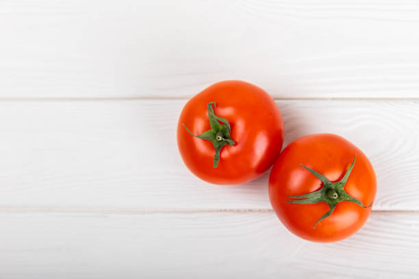 istock Tomatoes on marble texture background. Cherry tomatoes, yellow, pink, brown and black tomatoes in a bowl. Organic vegetables, harvesting.Vegan. Fresh ripe tomatoes. copy space. 1718851667