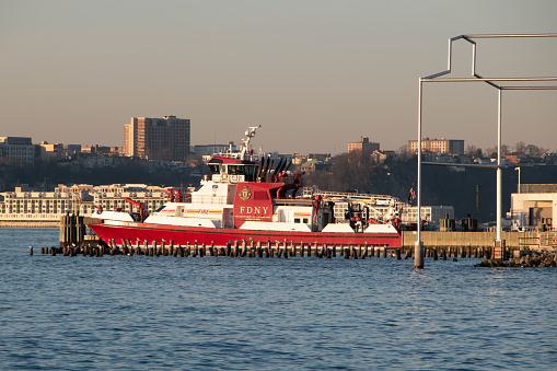 An FDNY boat is docked at the pier near Little Island in New York City, ready to respond to emergencies on the water.