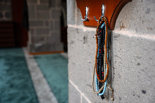 Prayer beads hung on the wall inside the mosque