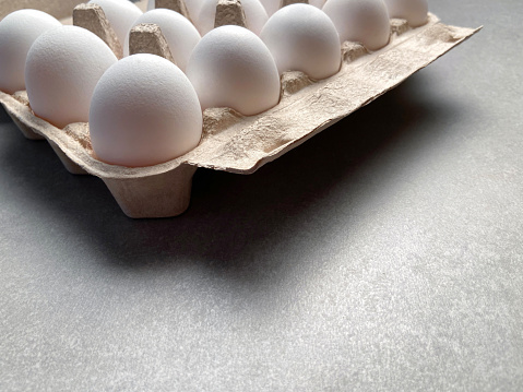 Fresh organic eggs in egg carton with copy space. Dozen eggs
