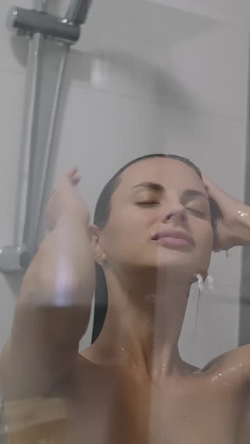 Woman taking a shower at bathroom