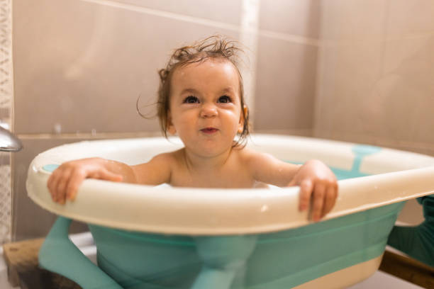 istock Funny little girl making a face while taking a bath 1718918669