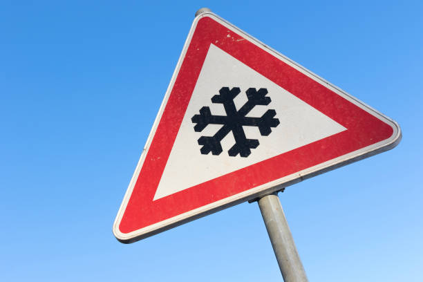istock German road sign: road ahead freezes easily and is then slippery 1718930359