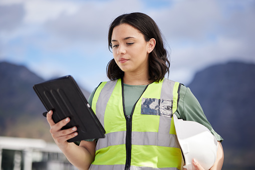 Thinking, engineering and woman with a tablet, outdoor and planning with renewable energy, safety and connection. Female person, architect and employee with technology, maintenance and inspection