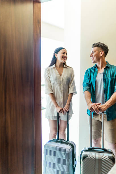 istock Couple talking and entering at hotel room 1718959923