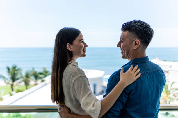 istock Couple talking in balcony at the hotel 1718960505
