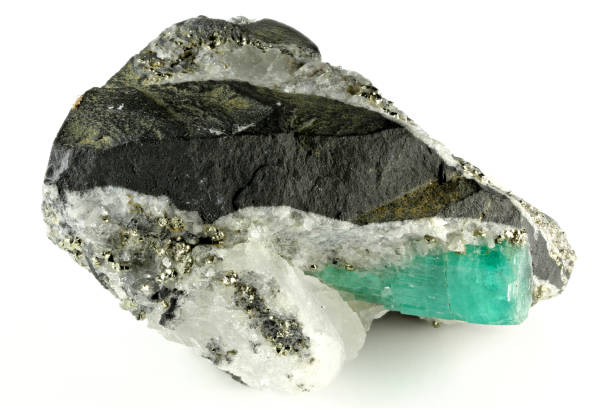 emerald nestled in bedrock from Chivor, Colombia isolated on white background
