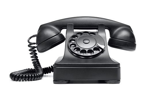 Black vintage rotary dial phonee on white background