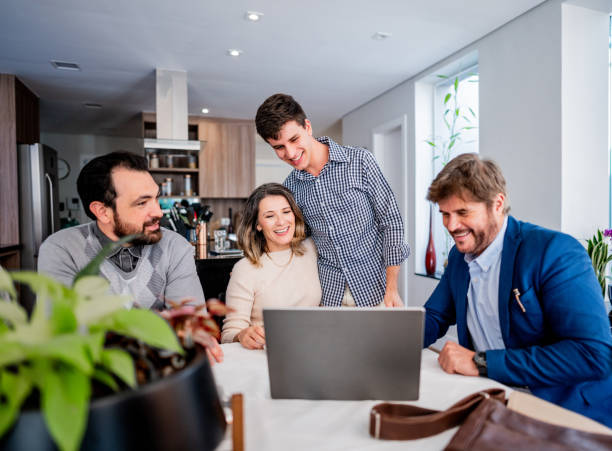 istock Finance advisor talking to family at home 1719003711