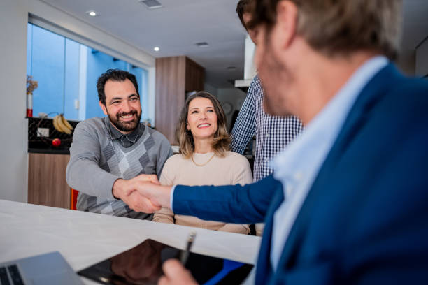 istock Family and advisor shaking hands at house 1719004804