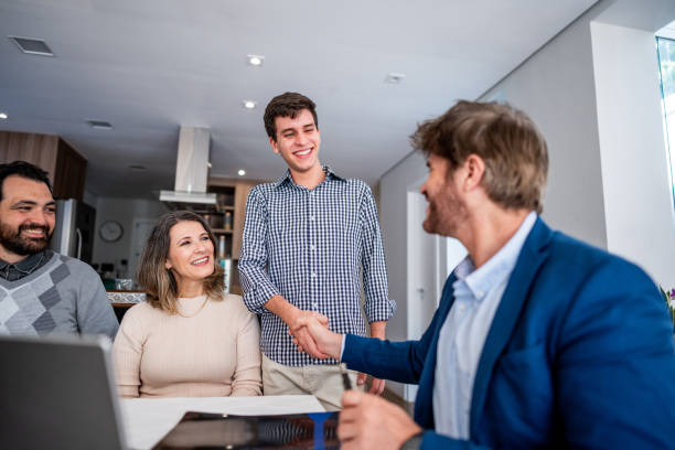 istock Son and advisor shaking hands at family house 1719005314