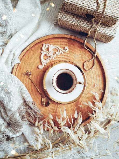 White coffee cup with book and flowers