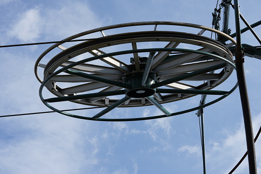 Large-diameter metal wheels as a part of ski lift used to change the direction of a haul rope.