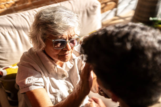 istock Grandmother caressing her grandson's face at home 1719010882
