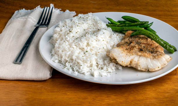 istock baked cod  with sauteed green beans and rice 1719011407