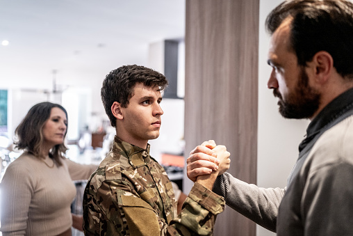 Army soldier greeting his father at home