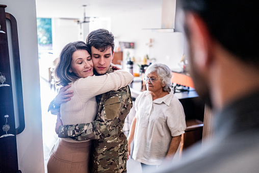 Army soldier embracing his mother after his return home