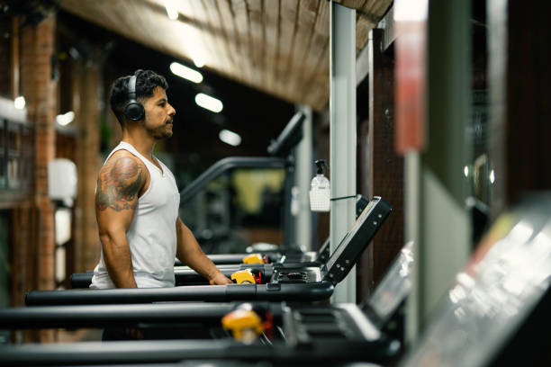 istock Fit young man working out on a treadmill at the gym 1719026677