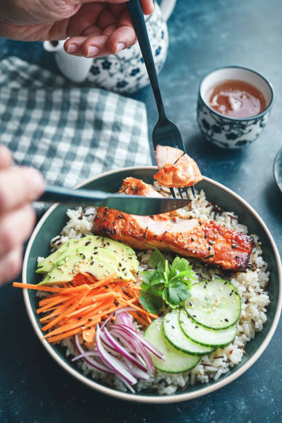 istock Spicy Salmon Bowl with Rice, Carrots, Cucumber and Avocado 1719032500