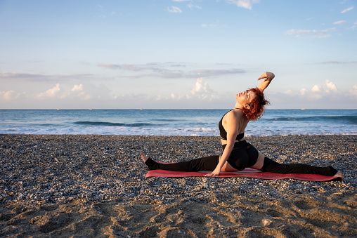 Yoga instructor performing asana poses at the seaside, A yoga instructor practicing