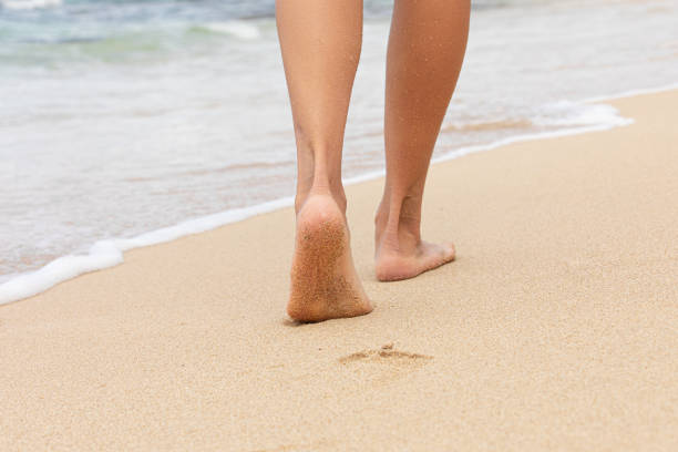 Woman walking on the beach in Hawaii.