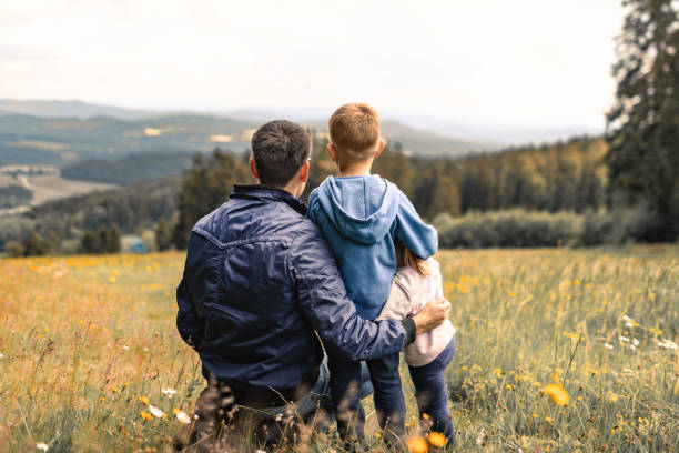 istock Father bonding with his son and daughter in nature surrounding. 1719079178