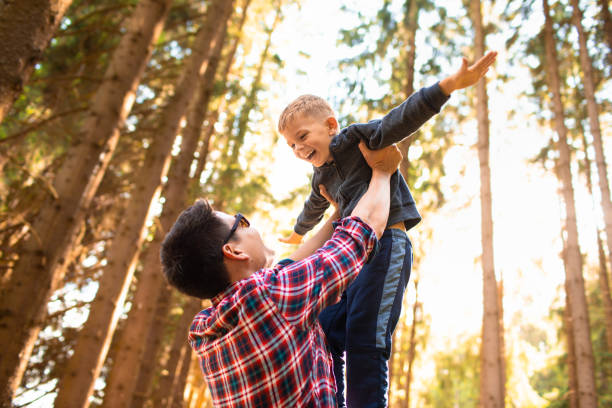 istock Father playing with his son in the forest. 1719079768
