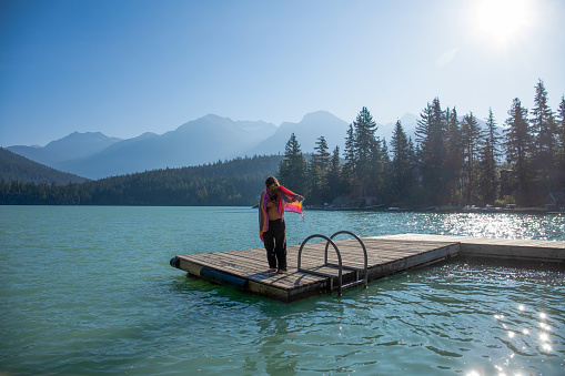 With her pregnant belly exposed, she soaks up the sunshine. At Green Lake, in Whistler, BC.