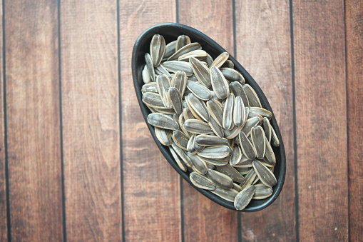 sun flower seeds in a bowl on table ,