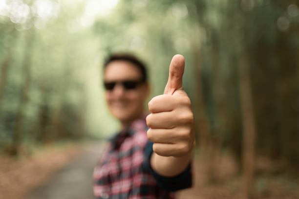 istock Man showing thumbs up in the forest. Healthy environment. 1719105479