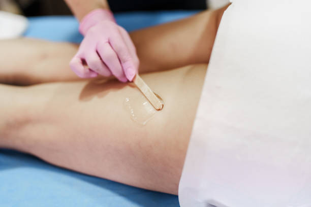 applying gel on woman's legs for massage