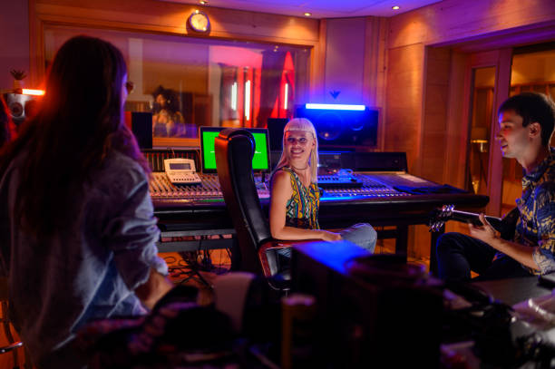 istock Band mates admiring the vocalist skills while she is being recorded. 1719177921
