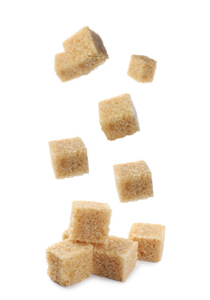 istock Flying cubes of brown sugar on white background 1719189741