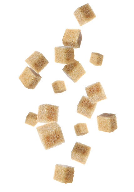 istock Flying cubes of brown sugar on white background 1719189748