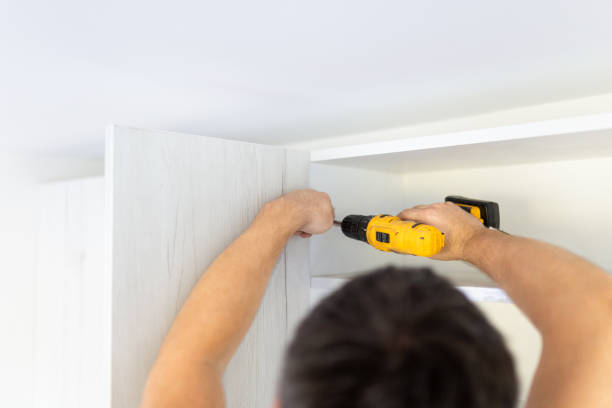 istock Carpenter process of wood door hinge installation 1719195720