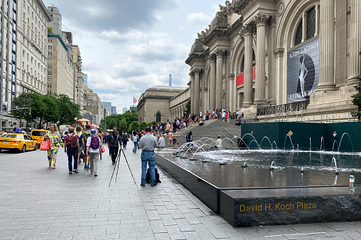 The Metropolitan Museum of Art, an iconic cultural institution, stands amidst the bustling streets of Manhattan on 5th Avenue in New York City, USA.