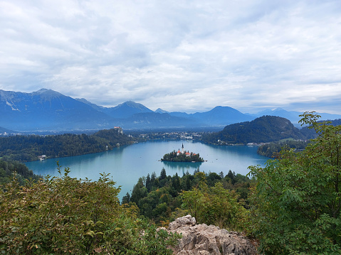 view to the island on lake Bled and dark blue mountains.  Slovenia.