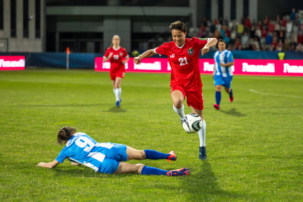 istock Woman soccer player leading ball 1719200547