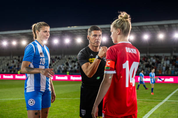 istock Soccer referee shaking hands with teams captains 1719200582