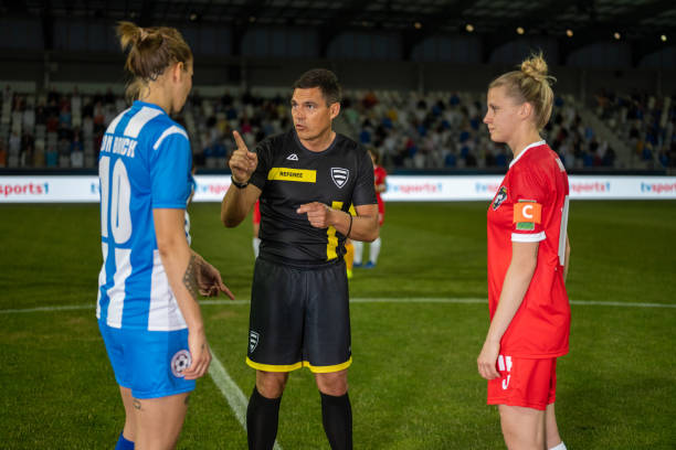 istock Soccer referee and team captains meeting on field 1719200590