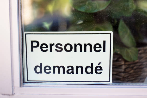 istock Storefront sign help wanted in french personnel demande. 1719209762