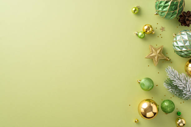 istock Infuse your space with Christmas magic. Overhead photo showcasing emerald, golden tree trinkets, luminous star, glistening sequins, frost-covered fir, cone on soft green, space for message or promo 1719212474
