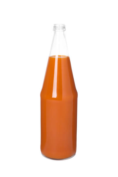 istock Fresh carrot juice in glass bottle isolated on white 1719215859