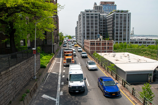 Busy Brooklyn road with a stream of cars, capturing the vibrant urban life in Brooklyn Heights, New York, USA.