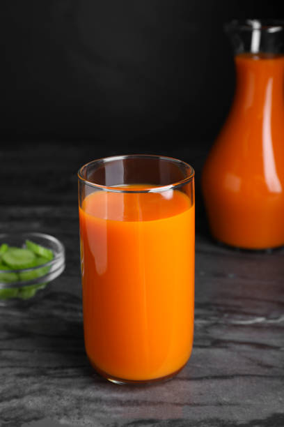 istock Tasty refreshing carrot juice on black marble table 1719217065