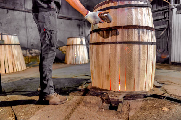 istock A worker at a cooperage in Jerez measures the temperature of the barrel while its interior is roasted in the oven. There are three different types of roasting. This barrel has the highest toasting. It will be used to mature whiskey. 1719224098